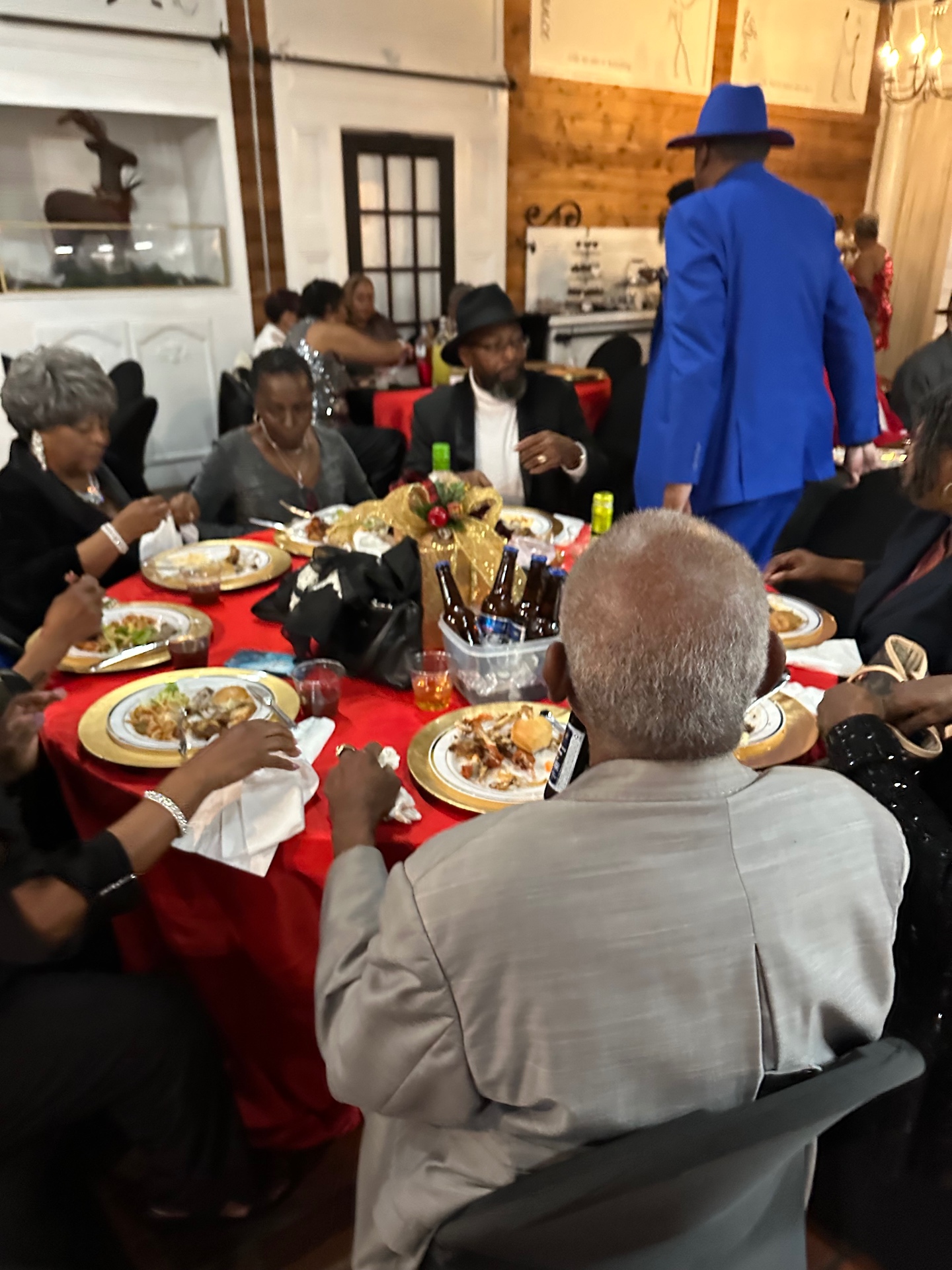 Holiday gathering with red linens and gold chargers
